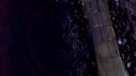 Smooth aerial shot of the lighthouse and large ship entering harbour and a ci Stock Footage 101832012
