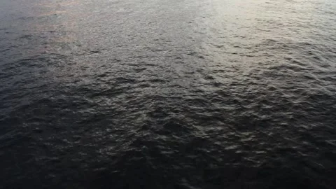 Smooth aerial shot moving over the ocean surface, looking straight down to Stock Footage 337218478
