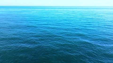 Smooth Aerial Turn Over Deep Blue Sea Under a Clear Blue Sky Stock-Footage 341846534