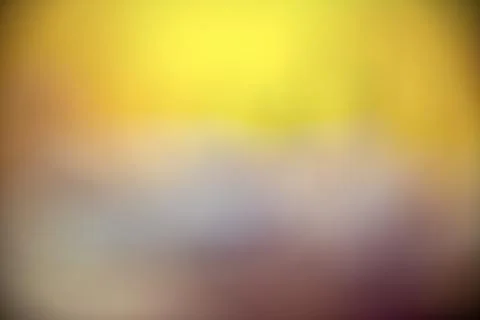 Smooth and blurry gradient background featuring a blend of yellow, orange, .. Stock Photos