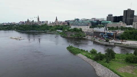 Smooth and scenic Ottawa river view of the supreme court and parliament Stock Footage 320889656
