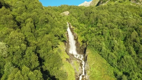 A smooth approach to a large waterfall in the middle of the forest. A strong Stock Footage 269298709