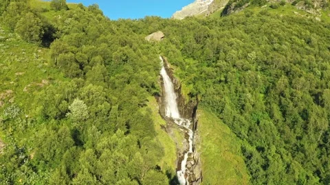 A smooth approach to a large waterfall in the middle of the forest. A strong Stock Footage 269299079
