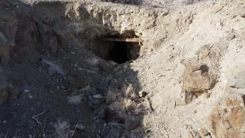 Smooth approach to opening of an abandoned mine shaft in the desert Stock Footage 243698547