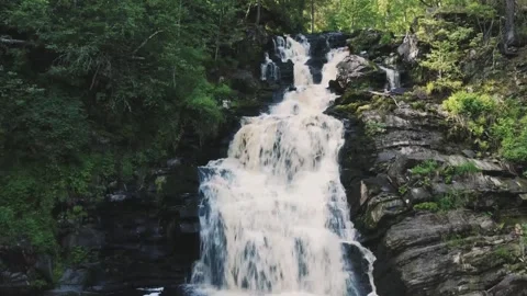 Smooth approach to the waterfall on a drone, above the river Vidéo 161824593