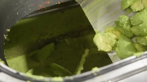 Smooth Avocado Puree Flowing Inside Food Processing Machine Stock Footage 334697935