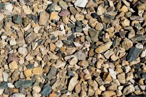 Smooth background with a texture of different sizes of pebbles. Pebble beach Stock Photos