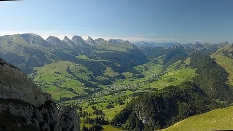 Smooth backwards Drone shot of alpine Valley and Churfirsten during daytime Stock Footage 122220169
