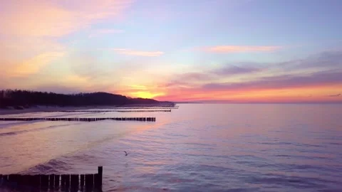 A smooth Baltic coast flight at golden hour reveals Ustronies quiet winter ch Stock Footage 308403967