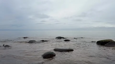 Smooth Baltic Sea Waves Washing Over Sandy and Rocky Shore in 4K with Sound Stock Footage 323010164