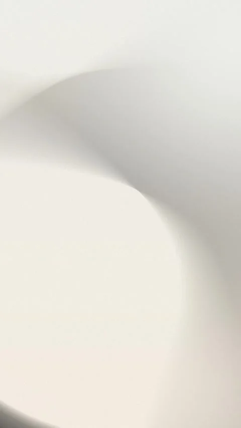 Smooth beige and gray gradients create a soft abstract curve. Seamless loop 動画素材 309956932