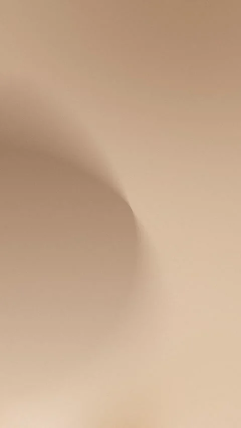 Smooth beige gradient with soft curves, seamless loop background, 4K clarity. Stock Footage 309956978