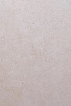 Smooth beige stone surface with subtle textures and patterns in natural lighting Stock Photos