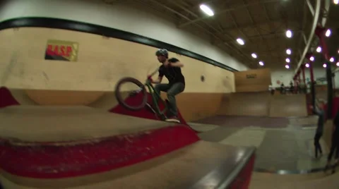 Smooth bmx rider boosts a box jump with style Stock Footage 51702743