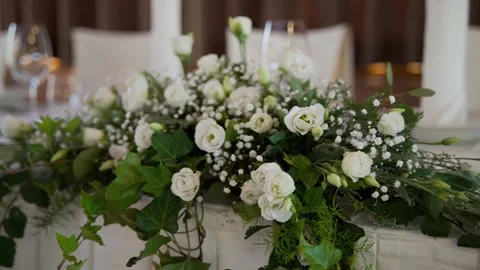 Smooth camera movement along the table decorated with white flowers. Stock Footage 247124370