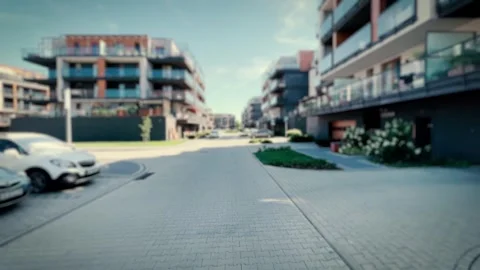 Smooth camera movement through a modern residential block neighborhood. Blu.. Stock Footage 243641931
