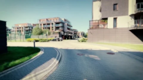Smooth camera movement through a modern residential block neighborhood. Blu.. Video stock 243642174