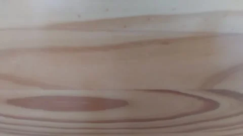 Smooth camera pan over a natural pine wood texture on furniture Stock Footage 337054085