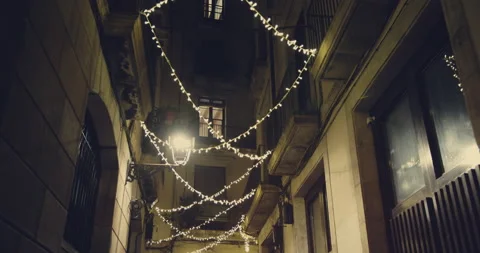 Smooth camera shot along narrow street at the night in the center of Barcelona Stock-Footage 140970867