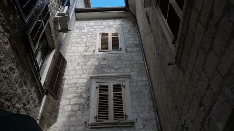 Smooth camera steady wide angle shot along street in the old town Kotor Stock Footage 103970172