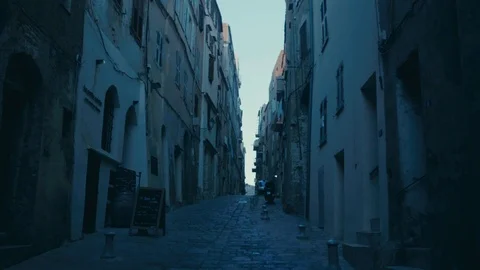 Smooth camera track of walking down a cobbled old street in southern european Stock Footage 88903419