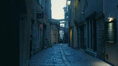 Smooth camera track of walking down a cobbled old street in southern european Stock Footage 88903433