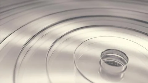 Smooth circular rings made of clear glass reflect light on a bright surface Stock-Fotos