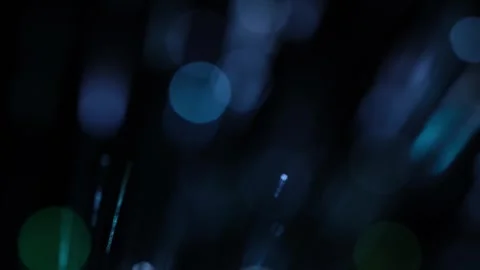 Smooth colorful bokeh lights shifting softly from purple to green in darkness. Stock Footage 342764357