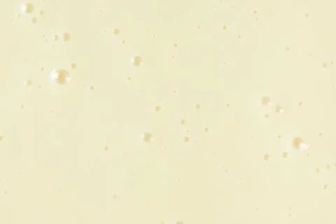 Smooth condensed milk texture with tiny bubbles macro. 스톡 사진