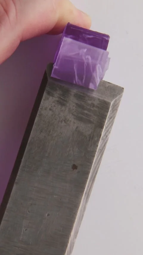 Smooth cutting of dark purple soap into long, soft strips. Stock Footage 310565152