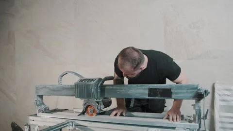 Smooth cutting in slow motion as a man operates a tile saw in a workshop Video stock 307040737