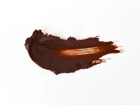Smooth dark chocolate spread on white background Stock Photos