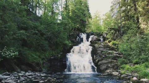 Smooth departure from the waterfall on a drone, over the river Video stock 161824601