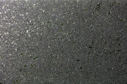 Smooth diagonal gradient with glitter of small colored granules on a black ba Stock Photos