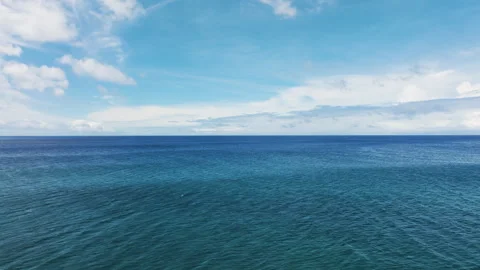 Smooth Dolly Over Calm Ocean with Clouds Stretching to Horizon Stock Footage 299329511