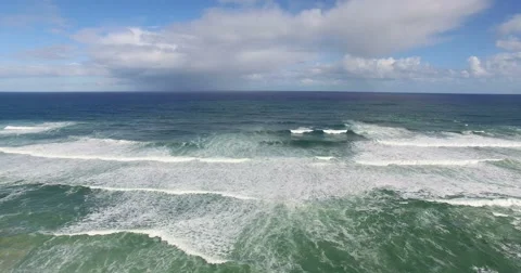 Smooth downwards tilt over rough waves breaking on the beach - South Africa Stock-Footage 65805672