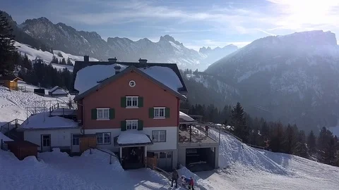 Smooth Drone crane-like shot of a chalet in the Swiss Mountains, low sunlight. Stock Footage 122220110