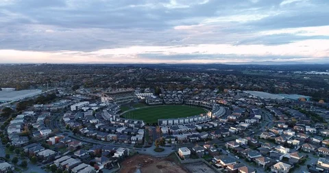 Smooth drone flying slowly towards an Australian rules football field, Stock Footage 114015807
