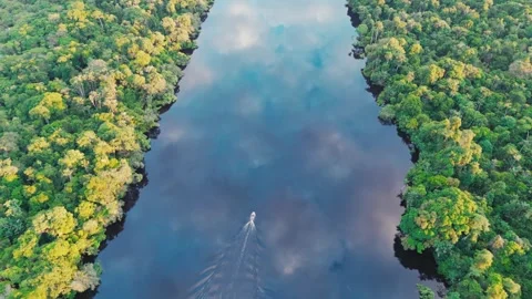 Smooth drone flyover of boat on Amazon river with cloud reflections Stock Footage 322127516