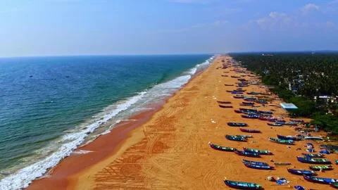 Smooth drone glide along expansive sandy beach with repeating wave patterns and Stock Footage 325842380