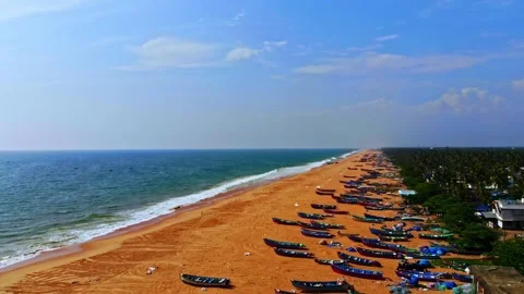Smooth drone glide along expansive sandy beach with repeating wave patterns and Stock Footage 325842537