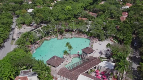 Smooth drone glide over the sun-drenched Venetian Pool, showcasing its massive Видео 332818721
