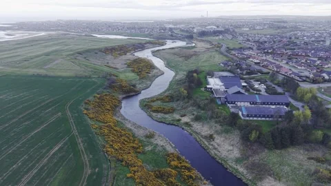 Smooth Drone Pullback Over River and Coastal Town Landscape Video stock 333784421