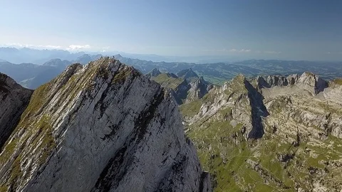 Smooth Drone shot of mountain summit and cliff on sunny day Stock Footage 122246379