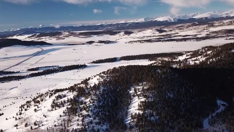 Smooth Drone Shot of Snow Covered Rocky Mountains Stock Footage 102068579