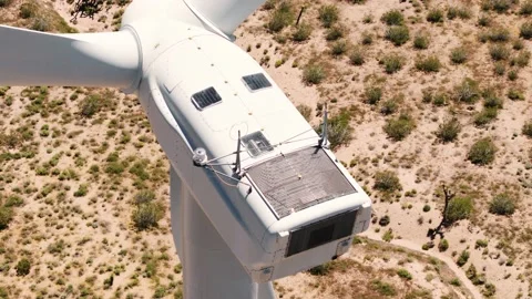 Smooth drone shot of spinning wind turbine in the Mojave desert on a sunny day Stock Footage 135703858