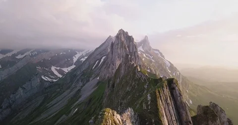 A smooth drone shot from a Swiss mountain ridge. This was taken at sunset. The Stock Footage