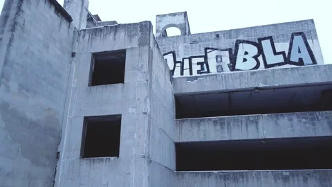Smooth flight of the camera, shooting an abandoned concrete building Stock Footage