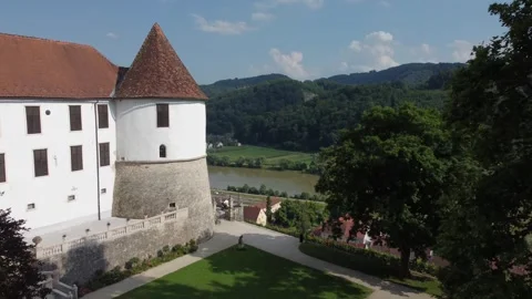 Smooth flight of the drone along the ancient castle overlooking the river. S Stock Footage 247121304