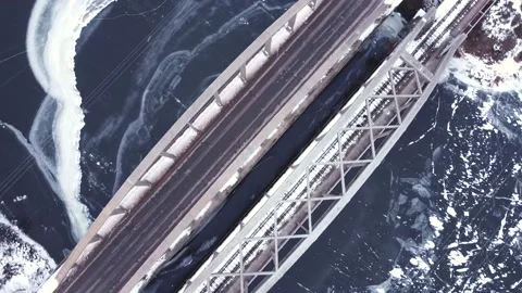 Smooth flight on a drone over a bridge and a frozen river Video stock 152832050